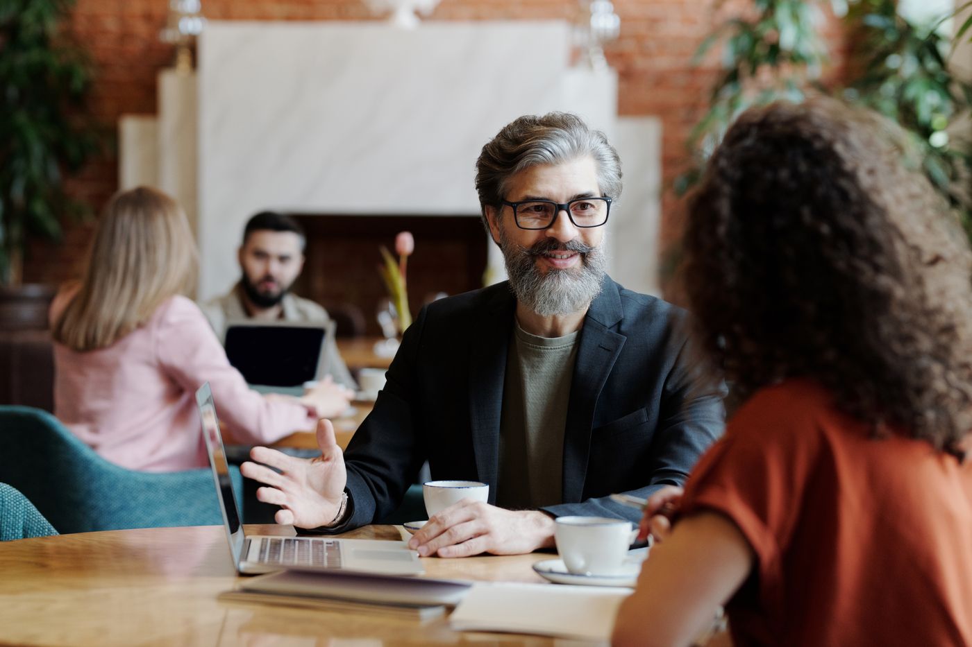 A local advisor talking through an advertising plan with a business owner over coffee
