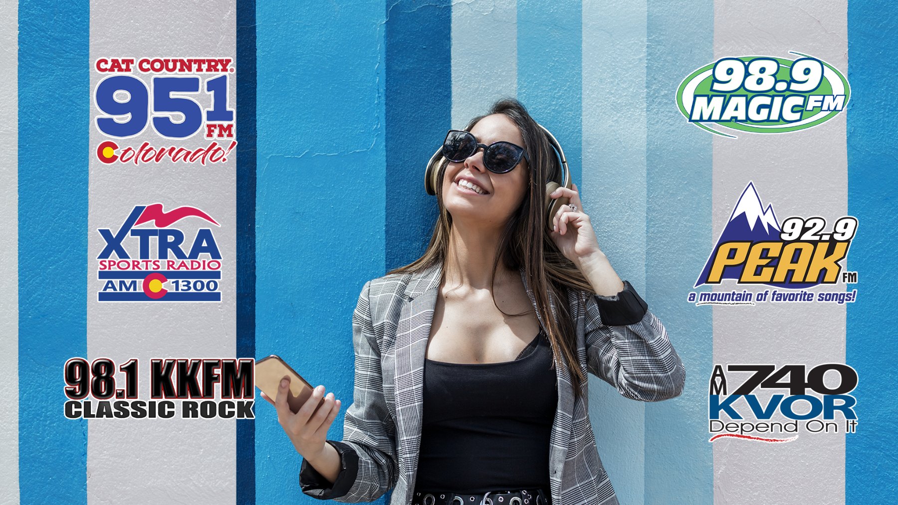 A smiling listener in headphones surrounded by our six station logos: Cat Country 95.1, Xtra Sports Radio AM 1300, 98.1 KKFM Classic Rock, 98.9 Magic FM, 92.9 Peak FM and AM 740 KVOR